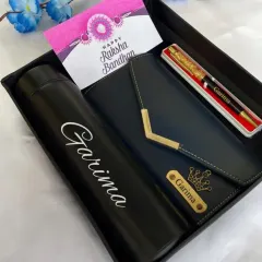 Surprise your sister this Rakshabandhan with a personalized hamper. This set includes a custom name bottle, a stylish clutch, a personalized wallet, and a beautiful pen.