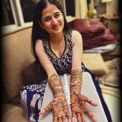 Another shot of Bhavin Bhanushali's sister, proudly showing off her detailed bridal mehndi. Her smile shows her happiness with the final design.