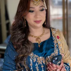 This candid photo captures the elegance of the complete look, from the intricate embroidery on her dress to the detailed henna and full glam makeup.