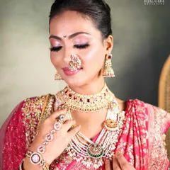 The quintessential Maharashtrian bridal look, featuring a crescent moon 'bindi', a traditional 'nath', and soft pink makeup that beautifully complements the pink Paithani saree.