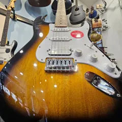 The iconic Fender FSR Stratocaster HSS in a timeless 2-Tone Sunburst finish. This close-up shows the beautiful wood grain and classic design that has defined generations of music. It represents the perfect blend of vintage feel and modern versatility we stock.