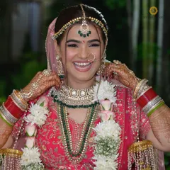 Nothing makes me happier than seeing a bride's joyful smile. Here, one of our lovely clients is radiant on her wedding day, wearing a complete bridal set with layered green bead necklaces.