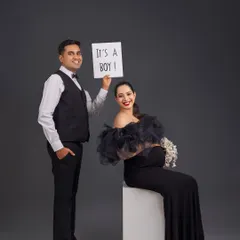 A classic and joyful gender reveal. The simple "It's a Boy!" sign combined with their happy expressions makes for a perfect announcement photo.