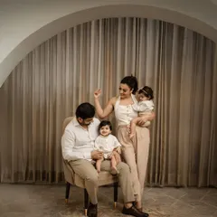 A playful, candid moment during a family studio session. It's these unposed interactions, the little whispers and shared smiles, that truly tell a family's story.