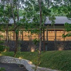Exterior views of The Leaf Poomala, where the building's stilted metal structure allows it to sit lightly on the terrain, preserving the natural landscape.