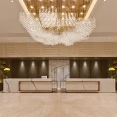 The lobby of a hotel is the first chapter of its story. Here, I designed a grand, welcoming space using a massive, cloud-like chandelier as the focal point. This is supported by precisely aimed downlights that accentuate the marble reception desks, ensuring the space is both awe-inspiring and functional.