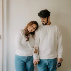A sweet and simple pose from an indoor session. Her head on his shoulder and their hands intertwined convey a sense of comfort, trust, and quiet love.