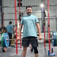 Functional fitness is perfect for busy professionals. This client is performing a deadlift, a fundamental movement that builds full body strength efficiently and prepares you for real life tasks.