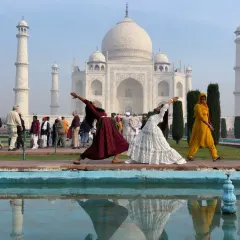Finding our flow with Virabhadrasana (Warrior Pose) in front of the Taj Mahal. The reflection in the water adds another layer of serenity to this powerful moment.