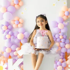 A sweet moment with her birthday cake. The pride and happiness on her face as she celebrates turning five is a memory to cherish forever.