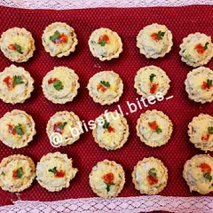 An overhead view of my chicken and cheese tarts, showing the consistent, bite-sized portions that are perfect for party catering and easy for guests to enjoy.