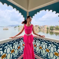 Styling for a vacation is about matching the energy of the place. For this trip to Udaipur, I chose a vibrant pink bandhani co-ord set that felt both festive and modern. The peplum top and tiered pants, paired with a traditional silver belt, created a look perfect for exploring the city's beautiful architecture by the lake.