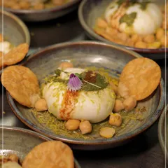 Our innovative Burrata Bhalla, a fusion dish that combines creamy Italian burrata with the tangy flavours of Indian chaat. It is served with crispy papdi and chickpeas, showcasing our culinary creativity.