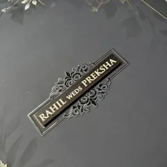 A close up on the embossed nameplate. The contrast between the dark background and the shimmering foil creates a focal point that is both elegant and modern.