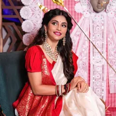 This full-length view showcases the complete traditional Bengali look. The combination of the designer saree, intricate jewelry, and my makeup and hair work creates a truly graceful and celebratory style.