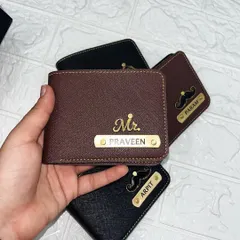 This brown personalized wallet features the "Mr." charm and the name "Praveen." The combination of the gold nameplate and charm against the rich brown color creates a classic, sophisticated look.