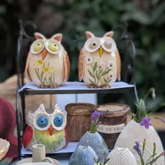 Here is a look at some of my owl vases and figurines on display. I offer a variety of styles, from colorful and quirky owls with big eyes to more rustic ones with floral paintings.