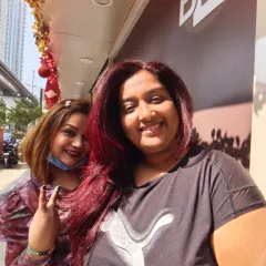 A happy client selfie with her new vibrant red hair. We love capturing these moments of pure joy right after a fresh color transformation.