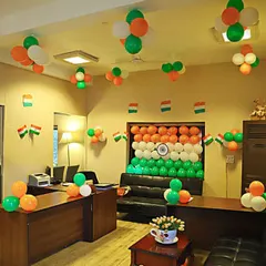 This image shows a wider view of an office decorated for Republic Day. I used balloon clusters on the ceiling and desks, along with a central flag backdrop, to fill the entire space with the tricolor theme.