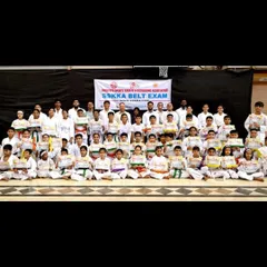 The entire SSKKA family after a successful belt exam. This group photo captures the sense of collective achievement and community support.