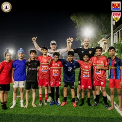 The joy of learning from the best. Our young players pose with coaches from VfB Stuttgart, feeling inspired and motivated after an intense training session. These interactions build confidence and a love for the game.
