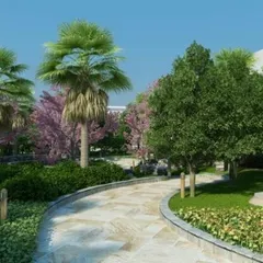 A winding stone pathway meanders through a lushly planted garden with palm trees and flowering shrubs. Our paths are designed to invite exploration and create a pleasant journey through the landscape.