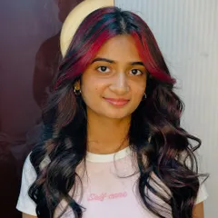 Your dream hair, our expert touch. This cherry red money piece adds the perfect pop of color to dark, wavy hair.