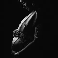 Sometimes, the most powerful stories are told in whispers of light and shadow. This black and white portrait, featuring a mother-to-be in a traditional saree, strips away all but the purest emotion. It is a soulful, timeless tribute to heritage and new life.