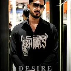 This is not just a shirt, it's an attitude. Featuring a bold, crystal-embellished gun graphic with the word 'Banks', this piece is for the man who is unapologetically sharp and always on target.