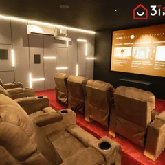 This angle shows the full seating arrangement and the scale of the 150-inch screen. The room is designed for a shared cinematic experience with family and friends.