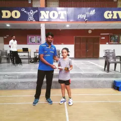 Presenting an award to one of my youngest players at a junior badminton championship. Nurturing talent from a young age is my focus.