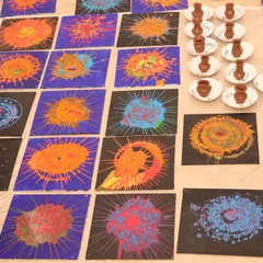 The amazing results of a spin art session. Each piece is a colorful explosion, and the collection shows the variety of designs created by the kids at the event.