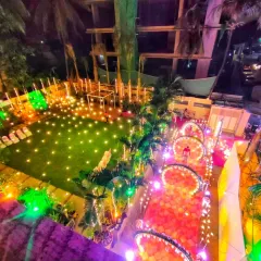 This aerial view shows how I can transform an entire outdoor space for a nighttime event. My work here included the illuminated arched walkway, lawn lighting, and the overall seating area layout to create a cohesive and magical environment.