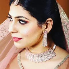 Celebrate Diwali with a complete, elegant look. This rose-gold plated necklace set with matching earrings and tikka is perfect for adding that festive sparkle.