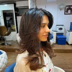 This profile shot highlights the shape and flow of the long layers, a haircut that looks stunning from every angle.