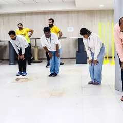 Participants engage in stretching exercises during a corporate fitness session. We emphasize proper form and safe movements to ensure a beneficial experience for all employees.