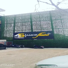 A large-scale green wall for the exterior of a commercial building. Covering the entire front with a simple green texture and a large logo makes a strong statement.