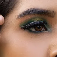 A macro shot of the green glitter smokey eye. In my classes, we get up close to perfect the details, from blending to glitter application, for a flawless finish.