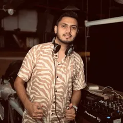 In my element, behind the decks. This is where I feel most at home, lining up the next track to keep the party moving. Ready for the beat to drop.