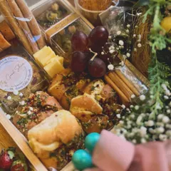 A peek at the savory side of the hamper, featuring fresh-baked garlic bread, olives, cheese, and breadsticks.