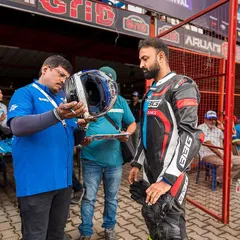 Safety first. A rider's helmet getting checked during the scrutiny process at the Bengaluru EV Festival. We ensure all gear meets safety standards.