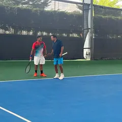 Players discussing strategy between games during a doubles match. Our league encourages tactical thinking and effective teamwork.