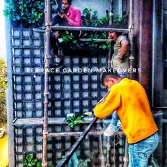 A candid shot of our team working high up on scaffolding to install a vertical garden. We are dedicated to our craft and committed to achieving excellence in every project.