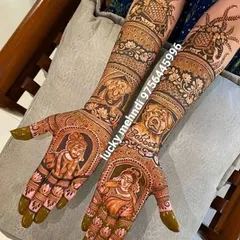 This unique bridal design was for a pet lover. It features portraits of the couple on the palms and their beloved dogs on the forearms, surrounded by floral patterns.