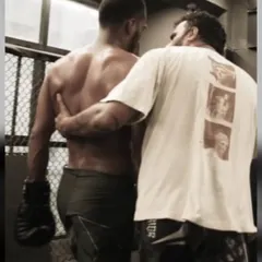 A quiet moment of guidance after a hard round. I am more than a coach shouting from the sidelines. I am in the trenches with my fighters, giving them the support and strategy they need.