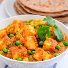 A classic North Indian delicacy, our Matar Paneer is a must-have for any celebration. We use soft paneer cubes and sweet green peas in a homestyle gravy that pairs perfectly with our fresh rotis.