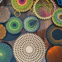 A stunning collection of string art pieces made by a community member. The bases were precisely cut on our laser cutter, providing the perfect canvas for these colorful geometric creations.