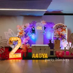 A light-up number '2' adds a personalized focal point to this butterfly party, surrounded by beautiful balloon clouds and butterfly accents.