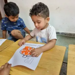 A child carefully works on a craft, showing the focus and creativity that our summer camp activities inspire. Every project is a chance to learn and grow.