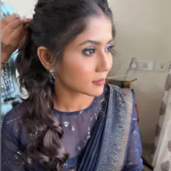 Another angle of the blue smokey eye look. The makeup is glamorous yet sophisticated, suitable for an evening event.